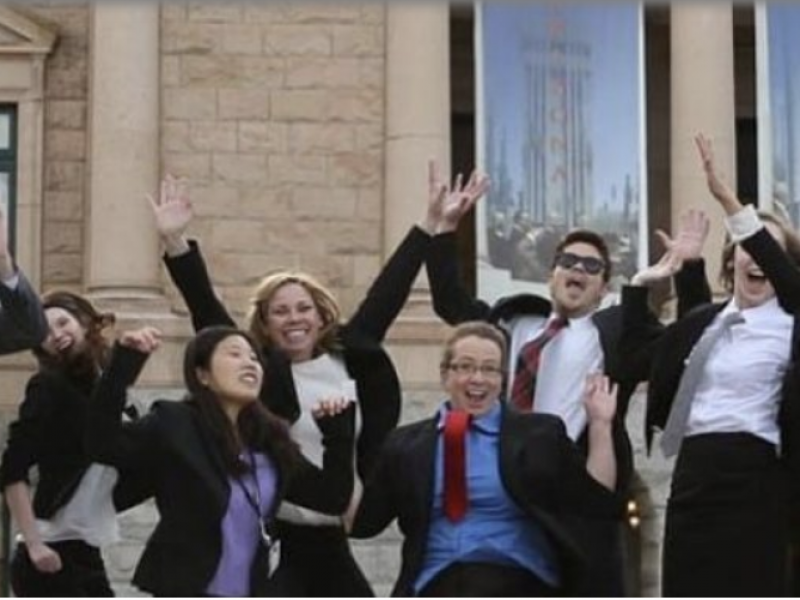 Interns jumping in front of A Z state capital.